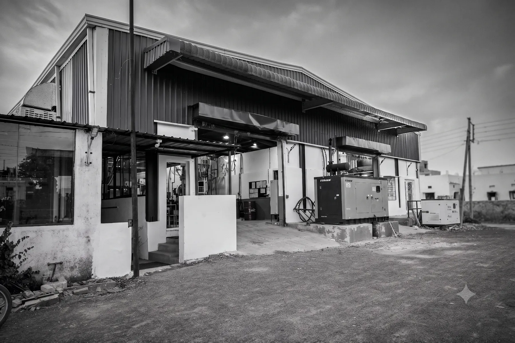 The Warora facility exterior, with open shop bays and standby generator sets